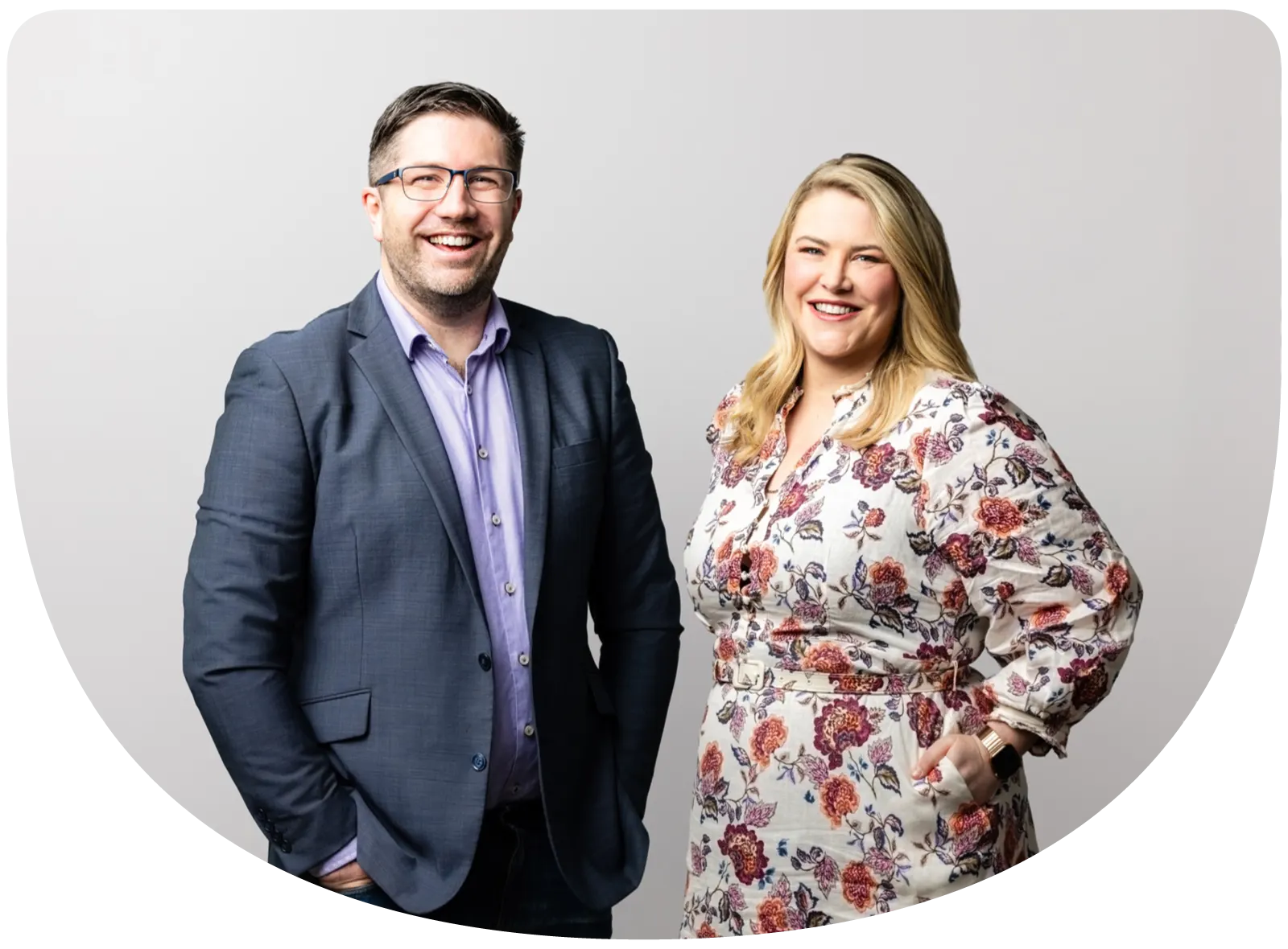 Chris and Camille standing together in a light studio